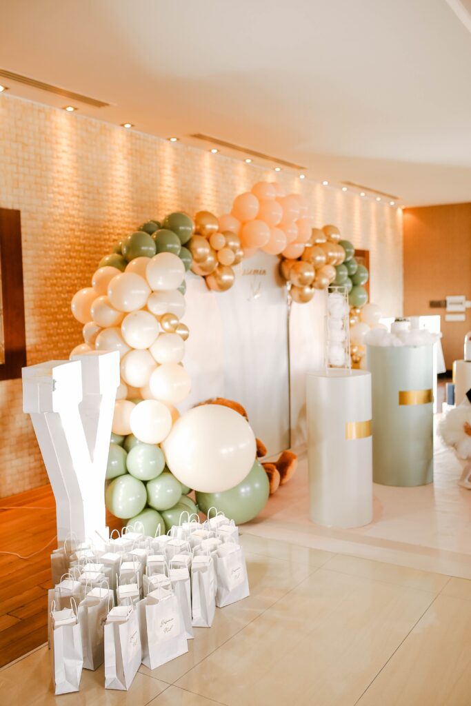 Stylish balloon arch with gift bags perfect for parties and celebrations.