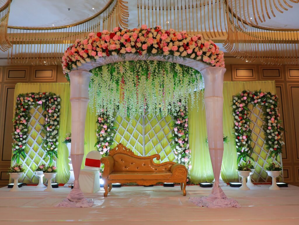 Luxurious wedding stage adorned with vibrant flowers and elegant design, perfect for celebrations.