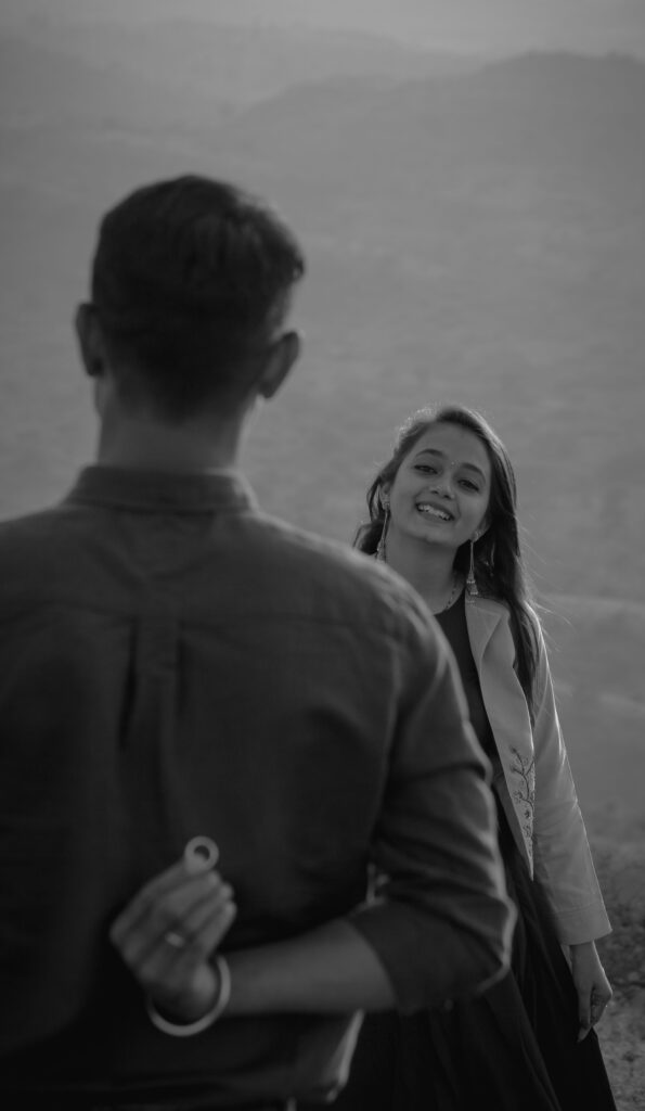 A romantic proposal captured in black and white, showcasing love and joy.
